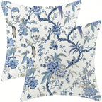 Floral and bird patterned pillows on a white background