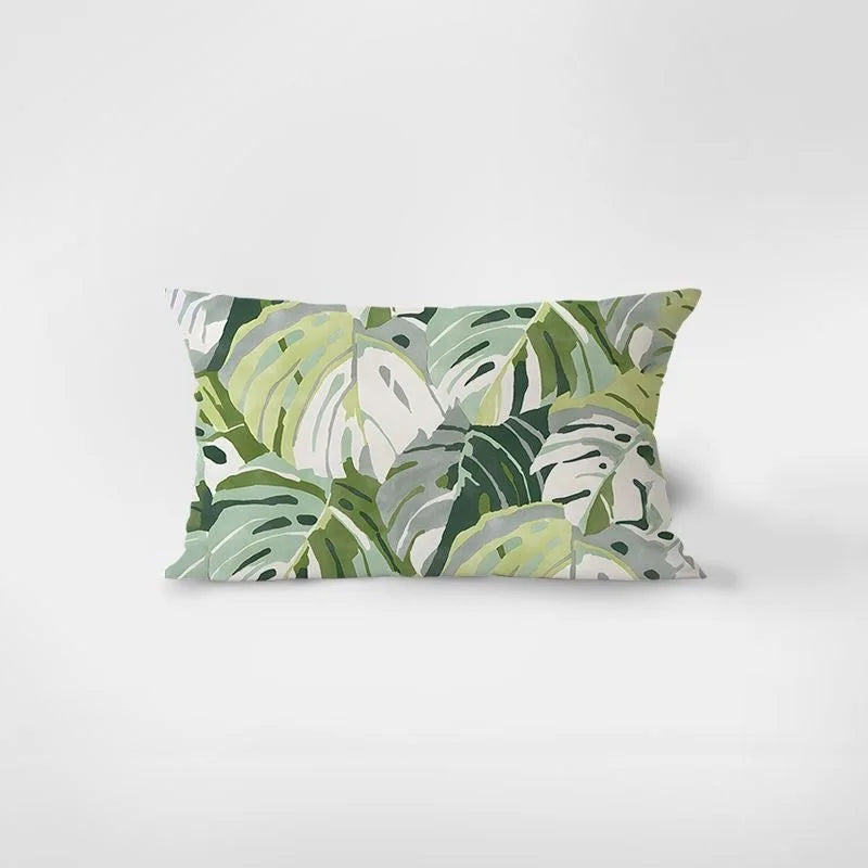 Decorative pillow with green leaf pattern on a white background