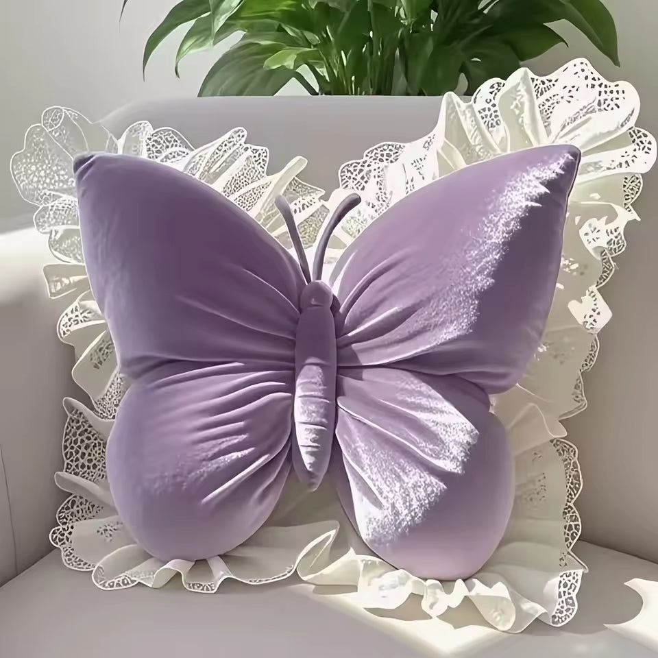 Purple butterfly-shaped pillow on a white surface with lace trim