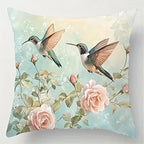 Decorative pillow with hummingbirds and flowers on a light blue background