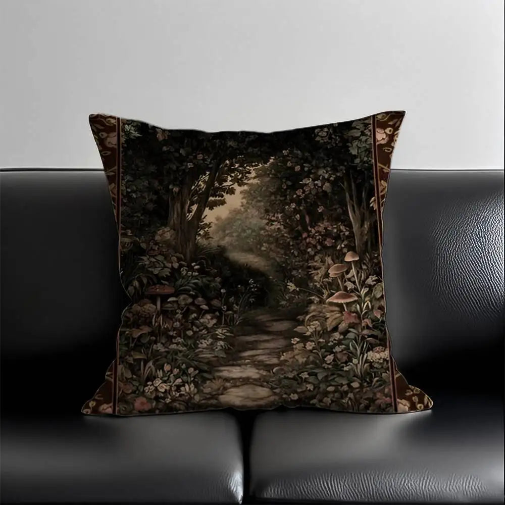 Decorative pillow with a forest design on a black leather couch.