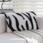 Zebra print faux fur pillow cover with black and white striped animal pattern on plush fabric