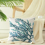 Decorative pillow with blue coral pattern on a chair