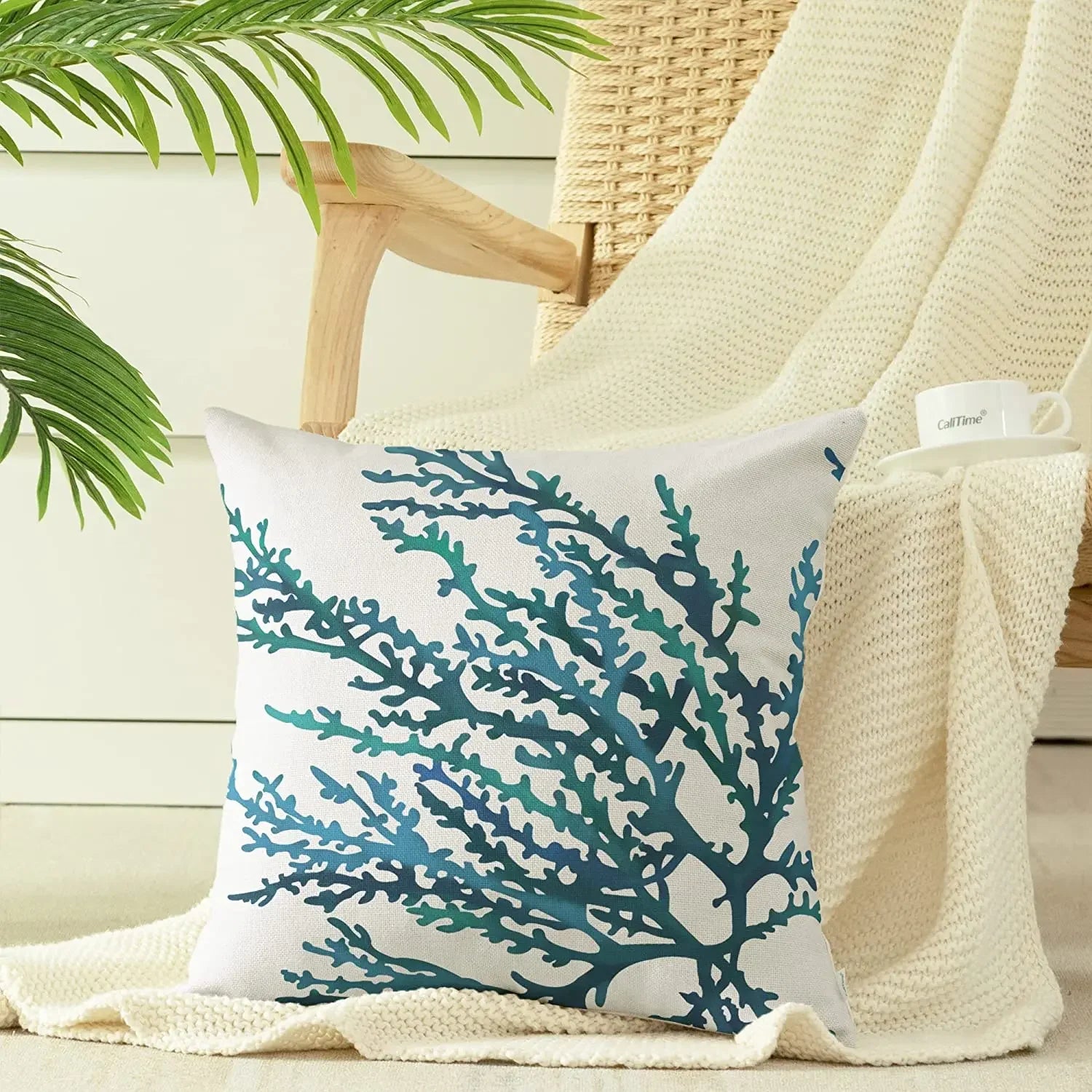 Decorative pillow with blue coral pattern on a chair