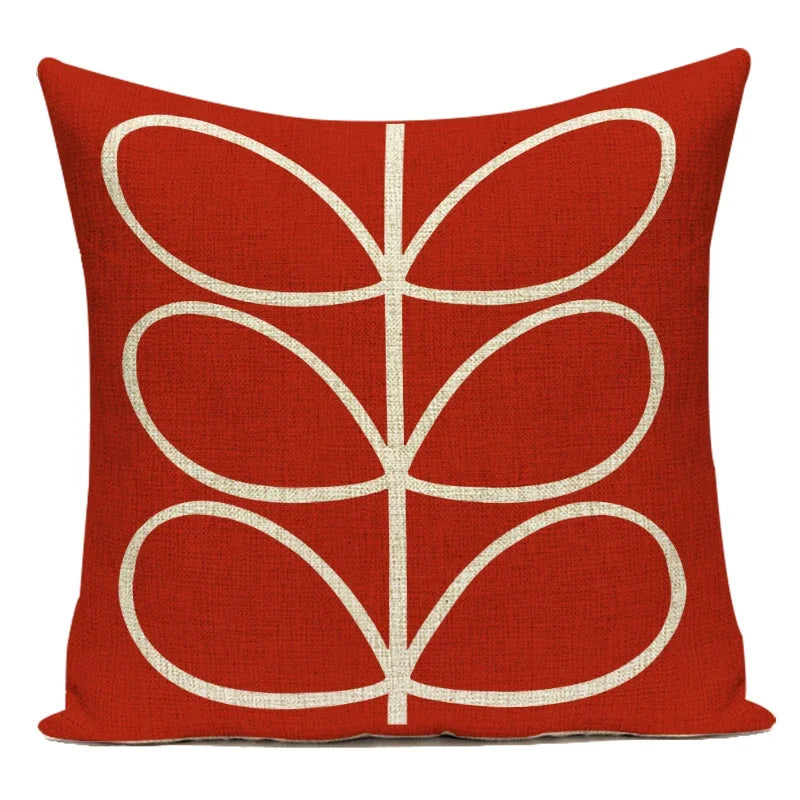 Red pillow with a white leaf pattern on a white background