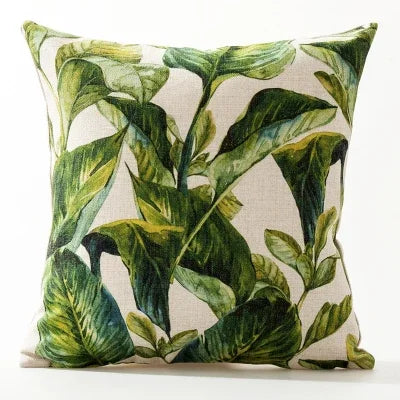Decorative pillow with green leaf pattern on a beige background