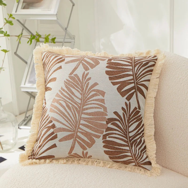 Decorative pillow with leaf pattern on a couch