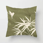 Green pillow with white leaf and bird design on a white background