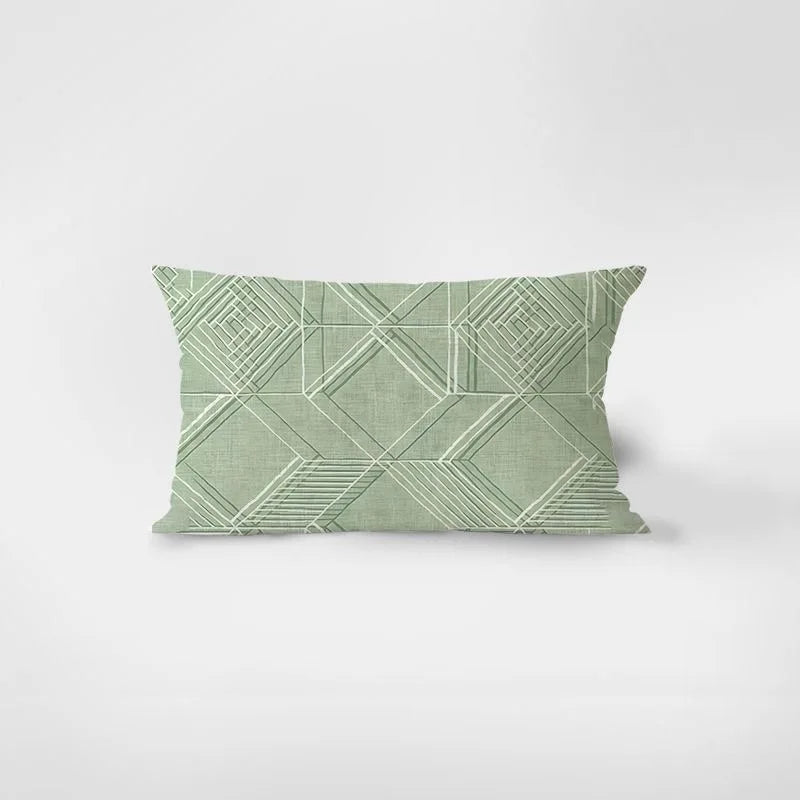 Green geometric patterned pillow on a white background