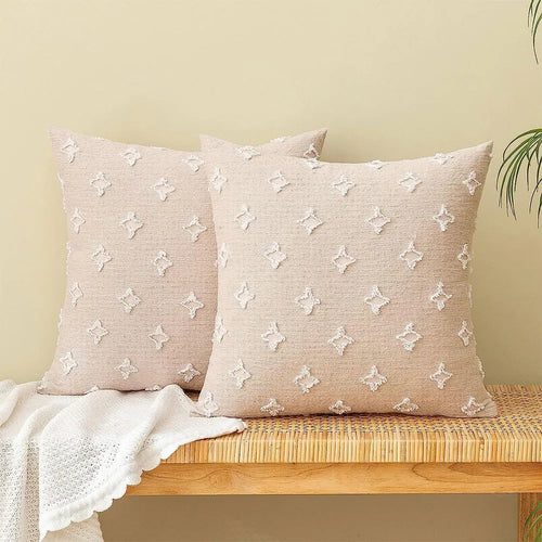Two beige tufted pillows on wooden bench.
