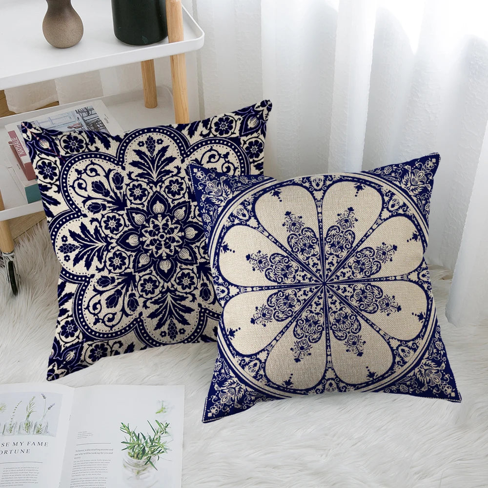 Two decorative pillows with blue and white patterns on a white surface.