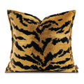 Decorative pillow with black and gold pattern on a white background