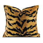 Decorative pillow with black and gold pattern on a white background
