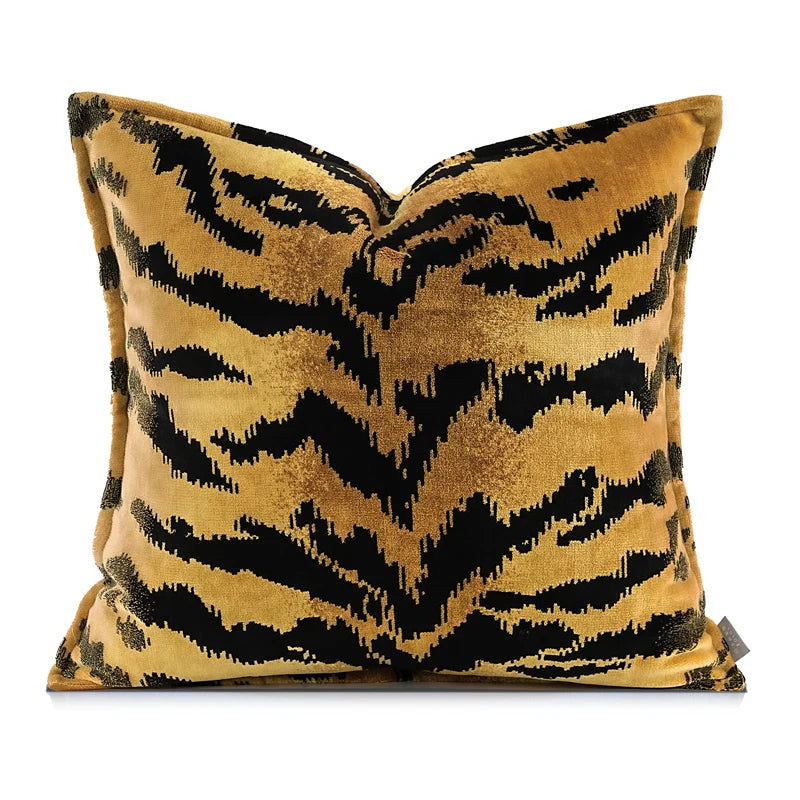 Decorative pillow with black and gold pattern on a white background
