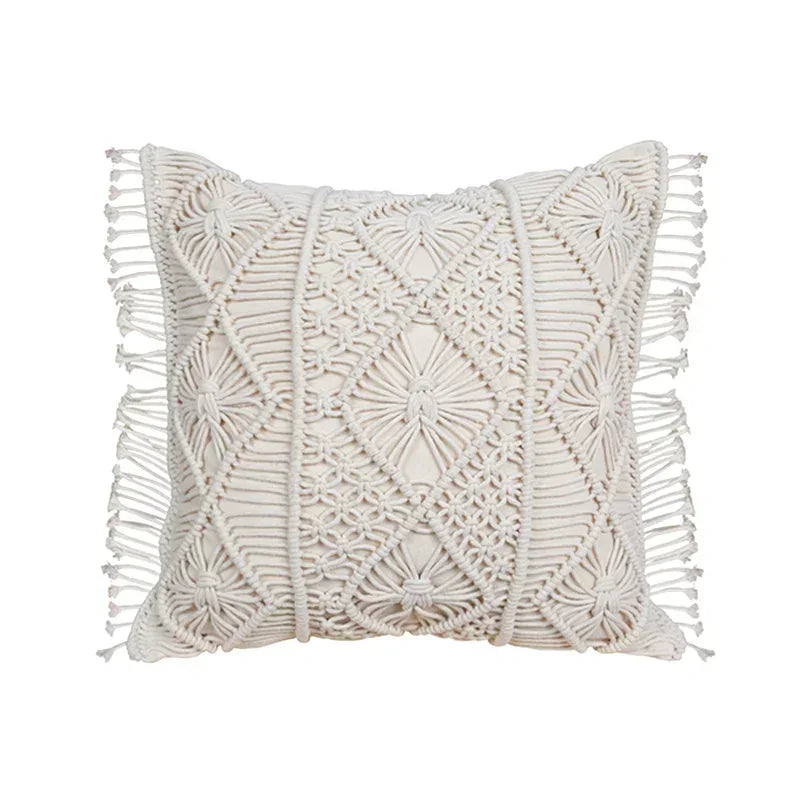 Decorative pillow with macrame pattern and tassels on a white background