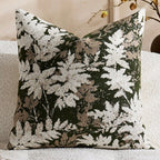 Decorative pillow with leaf pattern on a neutral background