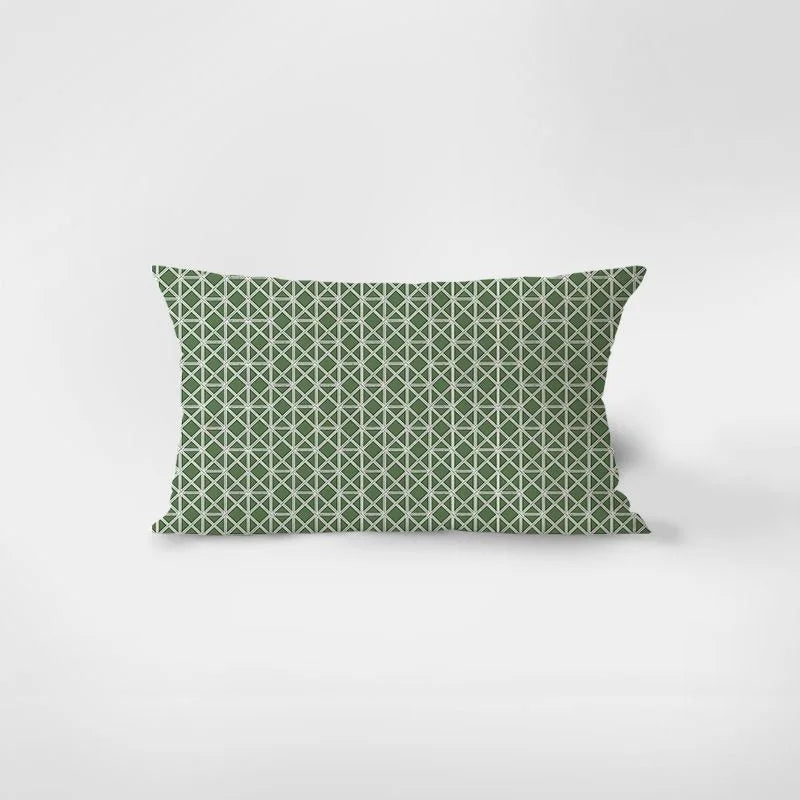 Green geometric patterned pillow on a white background