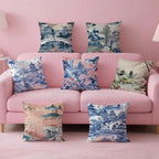 Set of decorative pillows with oriental designs on a pink sofa against a pink wall.