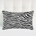 Black and white striped pillow on a white background