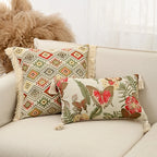 Decorative pillows with geometric and floral patterns on a beige sofa.