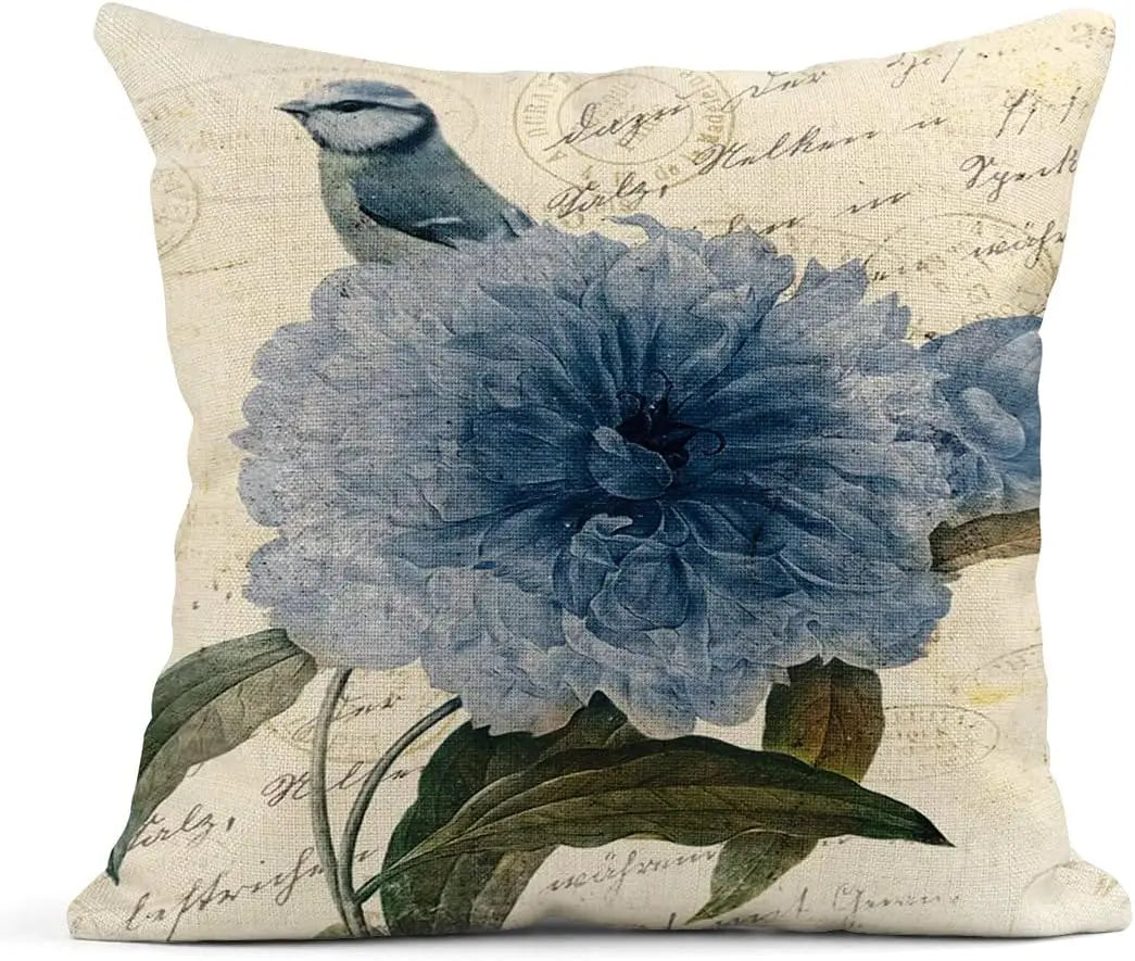 Decorative pillow with blue floral design and bird on beige background