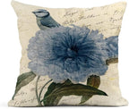 Decorative pillow with blue floral design and bird on beige background