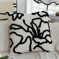 Decorative pillow with black abstract patterns on a white background