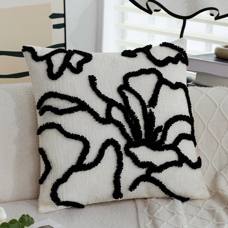 Decorative pillow with black abstract patterns on a white background