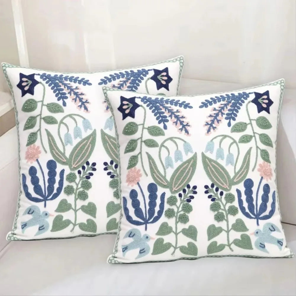 Two decorative pillows with floral patterns on a light background