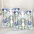Two decorative pillows with floral patterns on a light background