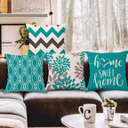 Decorative pillows on a couch with a winter scene outside