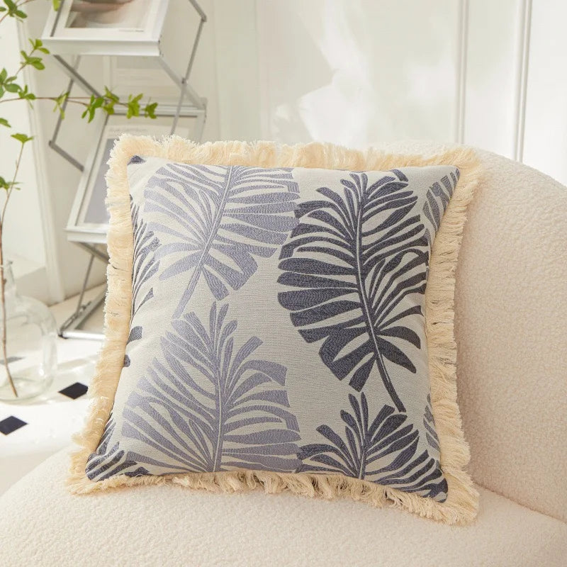 Decorative pillow with leaf pattern on a couch