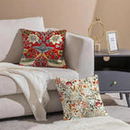 Decorative pillows with floral patterns on a sofa in a living room setting.