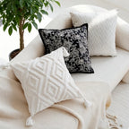 Decorative pillows on a sofa with a plant in the background