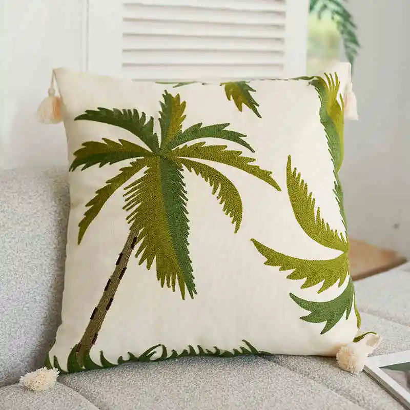Pillow with palm tree design on a couch