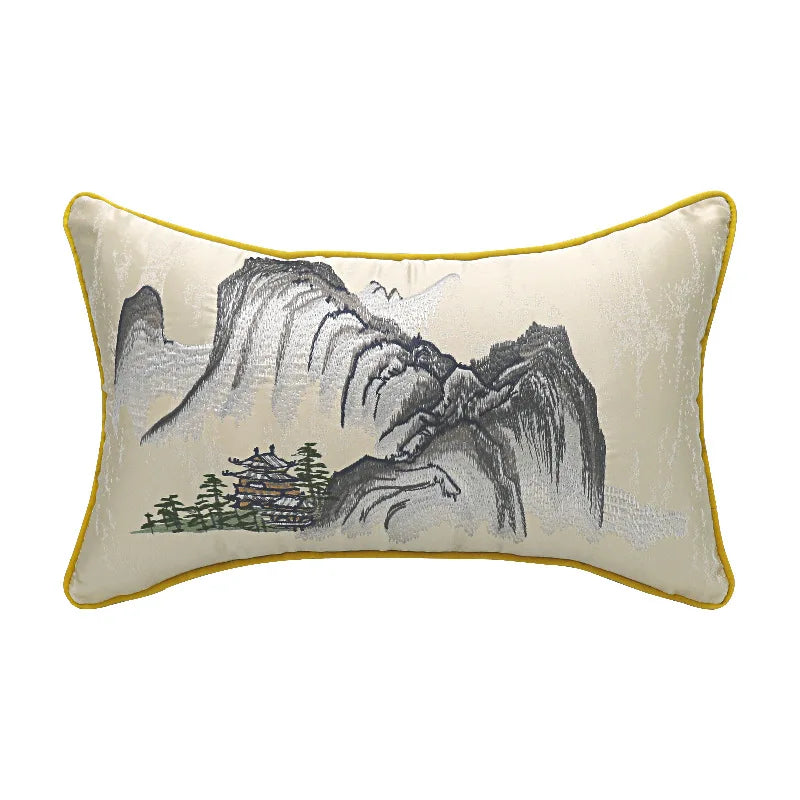 Decorative pillow with mountain and tree design on a white background