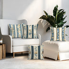 Decorative pillows with floral patterns on a white sofa in a living room setting.