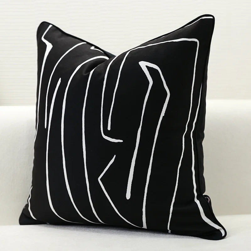 Black pillow with white abstract lines on a white background