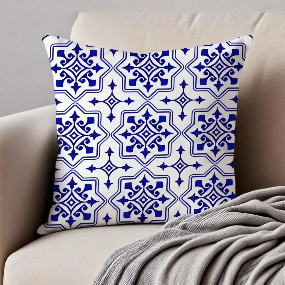 Decorative pillow with blue and white pattern on a beige couch