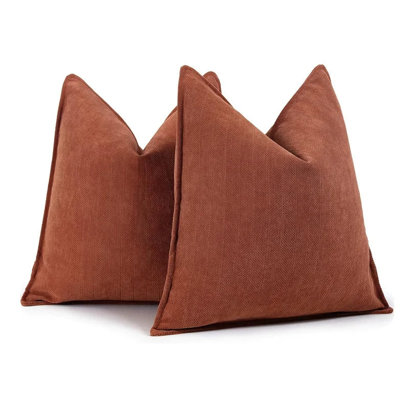 Two brown textured pillows on a white background